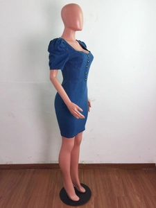 Side view of dark blue denim mini dress with puff sleeves and metal button closure