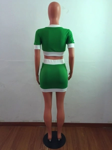 Back view of a green and white patchwork two-piece crop top and mini skirt set