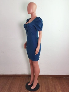 Side view of a slim fit dark blue denim dress with puff sleeves and front buttons