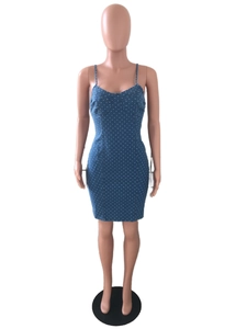 Detail of blue denim mini dress with white polka dots and bodycon stitching details