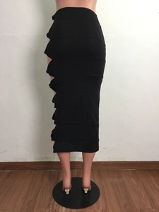 Detailed view of the side cutout design and knotting on a black bodycon midi skirt