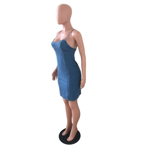 Detail shot of blue polka dot denim mini dress with thin straps and slim fit cut