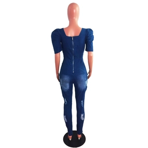 Rear view of denim jumpsuit with bubble sleeves, distressed details and back zipper