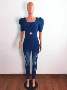 Detail of slim fit denim jumpsuit with puffed sleeves and waist cut-out accents