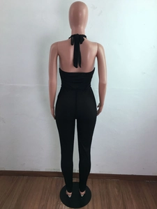 Detailed back view of sexy black halter jumpsuit with open back and lace-up design
