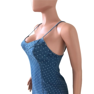 Detail view of the side profile on a blue polka dot denim bodycon mini dress