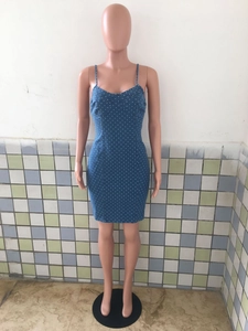 Detailed close-up of blue polka dot denim bodycon mini dress with thin straps