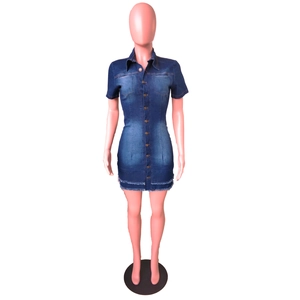 Detailed view of blue denim mini dress featuring metal buttons and raw hem finish