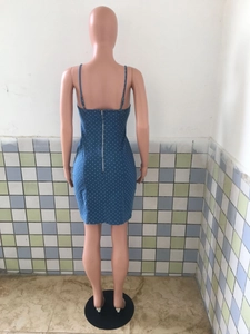 Detail view of the silver metal zipper closure on back of blue polka dot denim dress