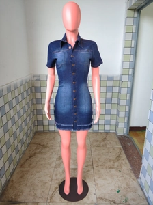 Close-up of slim-fit denim dress featuring metal buttons and frayed raw hem detail