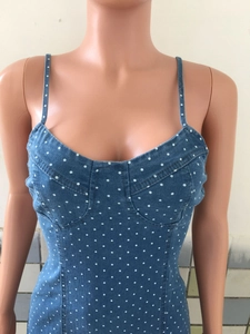 Detail showing the polka dot denim fabric with fine straps and contrast stitching