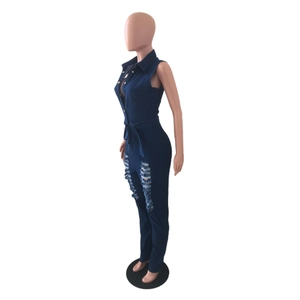 Détail d'une combinaison en jean sans manches bleu foncé avec trous usés et ceinture nouée