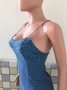 Detail of blue polka dot denim dress showing thin straps and side elastic seam tailoring
