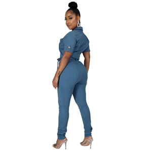Side view of short sleeve denim jumpsuit featuring a lapel collar and waist tie belt
