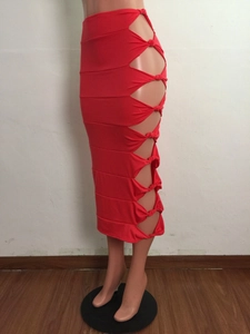 Detail of red hollowed-out skirt featuring side knot accents and a slim bodycon fit