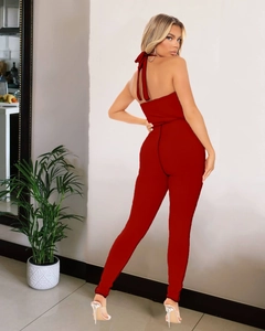 Detailed back view of a red backless halter jumpsuit featuring ribbed knit texture