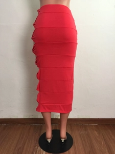 Detail of red ruched midi skirt featuring high-waist fit and elegant gathered side seams