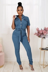 Detail of blue denim jumpsuit with button closure and adjustable waist belt tie