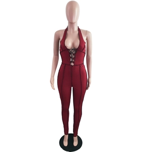 Macro shot of the deep red ribbed jumpsuit featuring a sexy lace-up V-neck detail