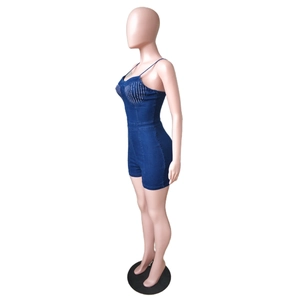 Side view detail of a slim fit dark blue denim romper with silver rhinestones on the chest