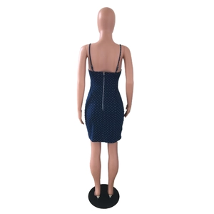 Close-up of the back zipper detail on a dark blue polka dot denim mini dress