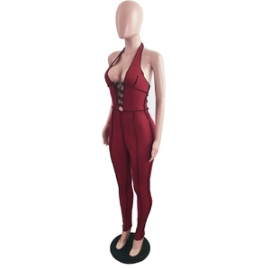 Detail of the halter neck and lace-up bodice on a burgundy ribbed slim fit jumpsuit