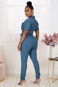 Detail shot of the back waist cinch and tailored fit of a navy denim jumpsuit