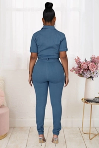 Rear view of short sleeve denim jumpsuit showing slim fit waist and back seam detail