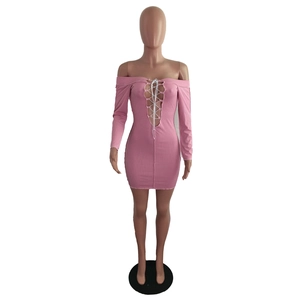 Close-up of the pink ribbed knit dress featuring a crisscross lace-up hollow neckline