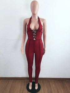 Detailed view of dark red ribbed fabric and front crisscross lace-up on sleeveless jumpsuit