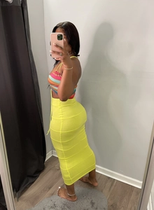 Detail of neon green high waisted bodycon maxi skirt with elastic knitted fabric