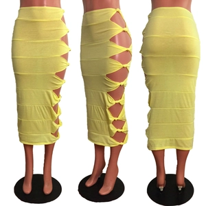 Detail of light yellow knit midi skirt featuring side cut-out and knot tie accents
