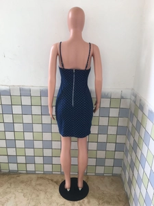 Detail of slim fit polka dot mini dress featuring back silver metal zipper closure