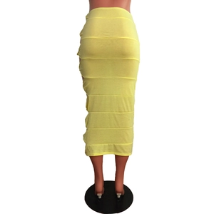 Detail of yellow knit skirt featuring side cut-outs and horizontal decorative stitching