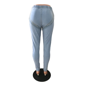 Detail of high waisted light blue stretch skinny jeans with V-shaped butt lifting seam