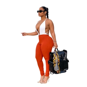 Women's summer two-piece outfit with white halter crop top and orange high waist skinny pants