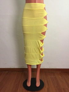 Detail of bright yellow knit skirt featuring side cut-outs and knotted tie accents
