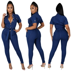 Detail view of dark blue denim jumpsuit with wooden buttons and waist tie closure