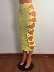 Detailed view of yellow bodycon skirt featuring side cut-outs and knot tie closures