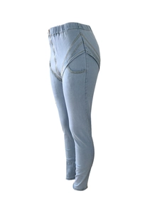 Close-up of light blue high waist stretchy jeans with unique cross curved seam detail