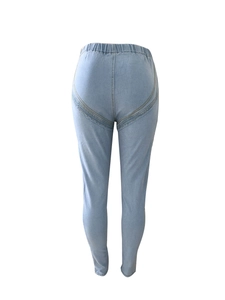 Detail view of high waist denim leggings with lifting seam and elastic waistband