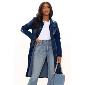 Close-up of distressed denim trench coat detail with frayed edges and metal buttons