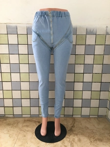 Detail of high waist stretch jeans with elastic waistband and front zipper design