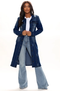 Detail of distressed long-sleeved dark blue denim trench coat with ripped shoulders