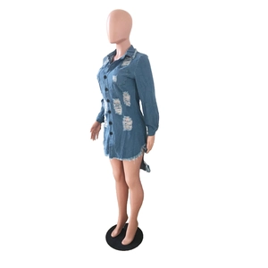 Detail of long sleeve denim shirt dress with distressed rips and frayed hem design
