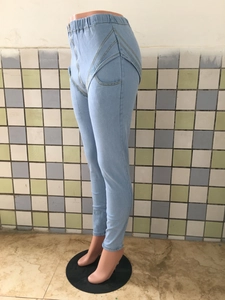 Detail view of high waist light blue stretch denim jeans with curved side stitching