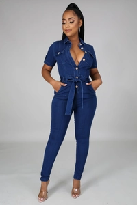 Detail of short sleeve denim jumpsuit featuring front buttons and waist tie design