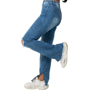 High-waist blue washed flared denim jeans with ripped knees and side slit leg openings