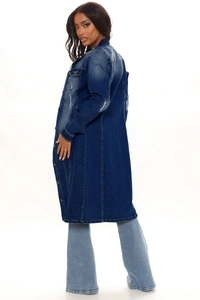 Detail of long denim coat with distressed ripped accents and vintage washed finish