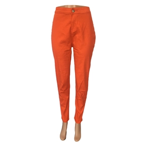 Detail view of vibrant orange high waist slim fit denim pants on a mannequin